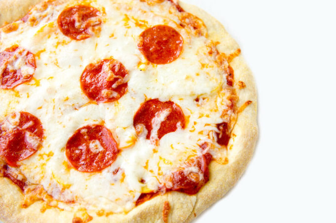 Cheese and Pepperoni pizza with a white background.