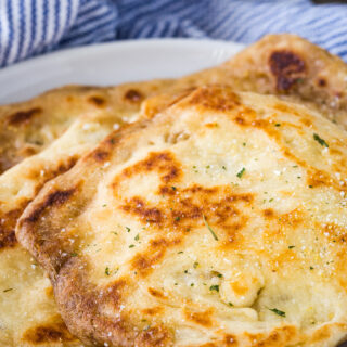 Flatbread Naan freshly cooked on plate.