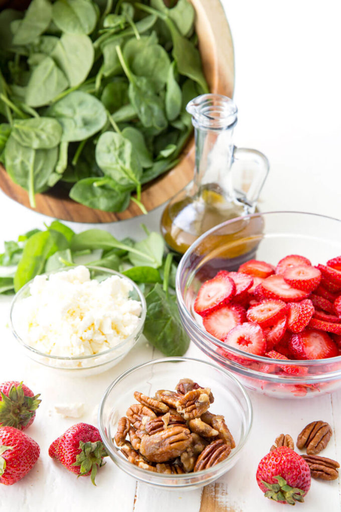 All the ingredients (not combined) of Strawberry Pecan Spinach Salad.