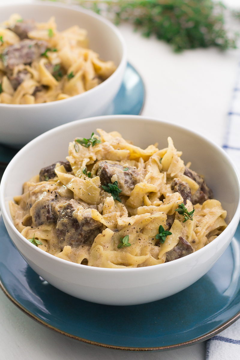 Slow cooker beef stroganoff in a white bowl