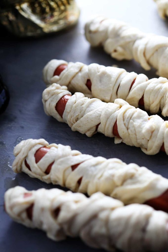 Mummy Dogs with Crescent Rolls, are a perfect meal for Halloween night and lots of fun for the kids! Mummy Dogs are a fun, festive, and easy meal.