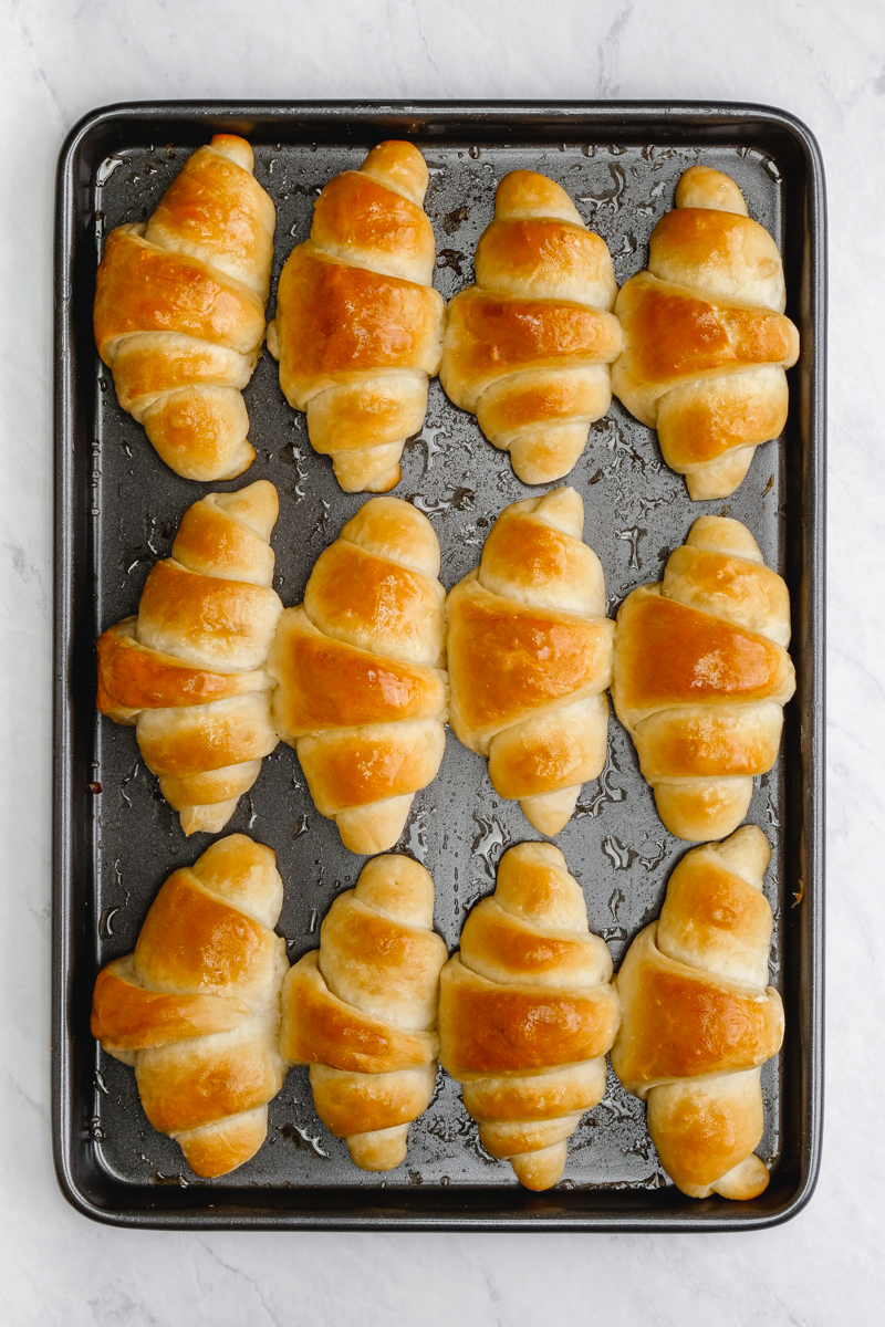 A sheet pan full of crescent rolls baked to a delicious golden brown perfection