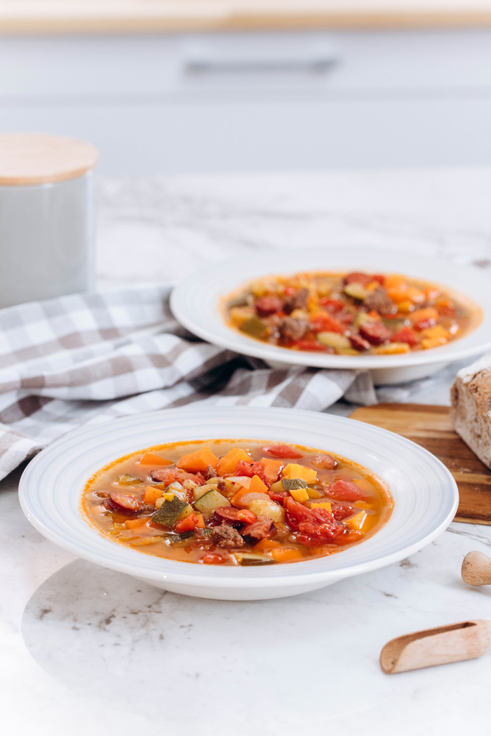 Beef and vegetable soup in two white bowls