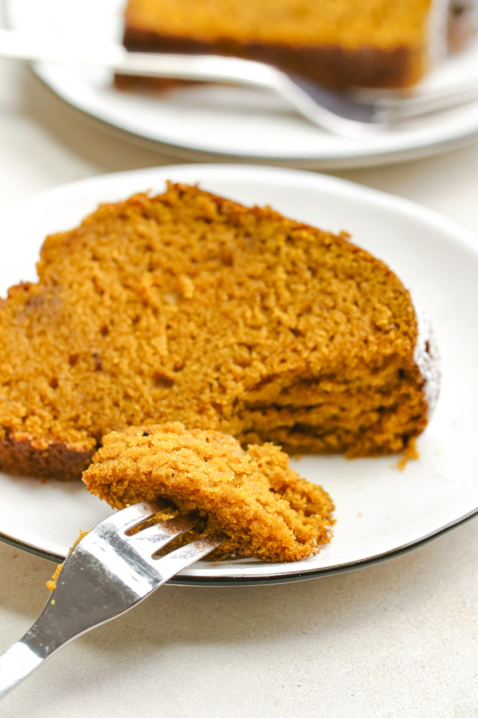 A slice of pumpkin cake, with a fork full of a piece
