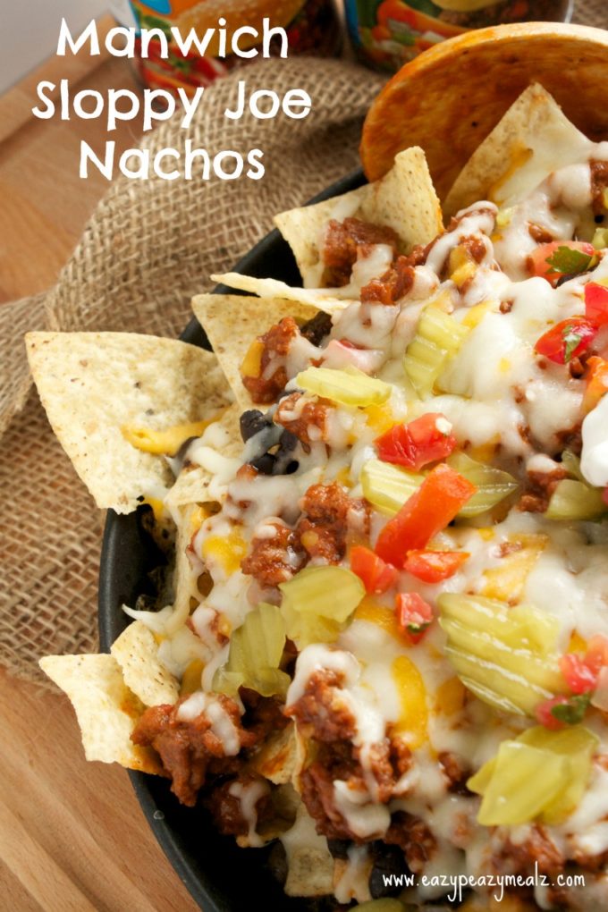Manwich Sloppy Joe Nachos: Ground beef with a sweet and tangy sauce, crispy chips, black beans, dill pickles, and of course plenty of cheese, sour cream and pico, make this a messy-licious meal kids and parents love!