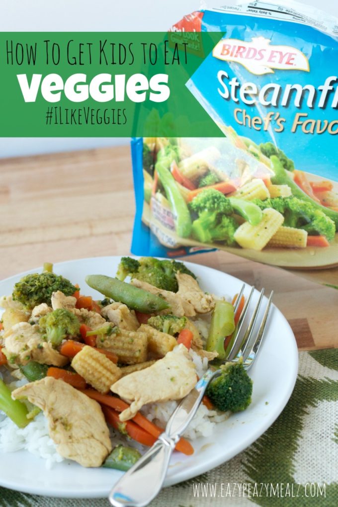 veggies on a white plate with a silver fork on the plate by the veggies with the steamed veggie bag to the side