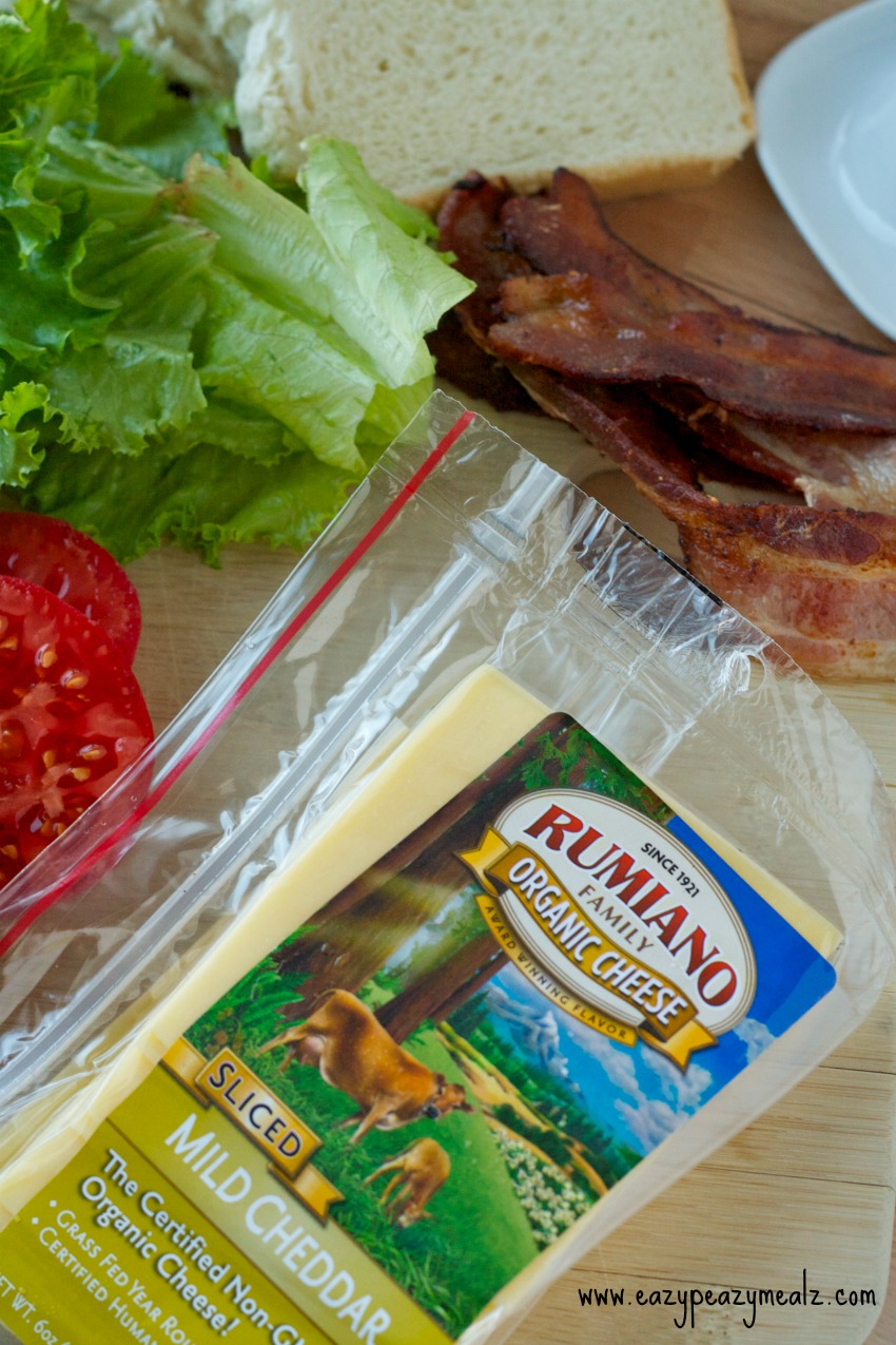 rumiano cheese with tomatoes, lettuce, bread and bacon to the side