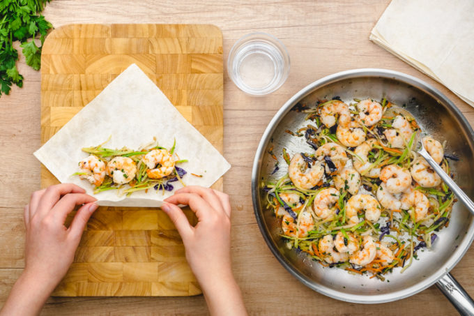 Making shrimp and veggie egg rolls