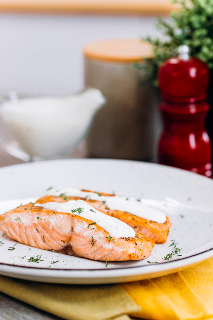 Creamy dill sauce over salmon fillets. 