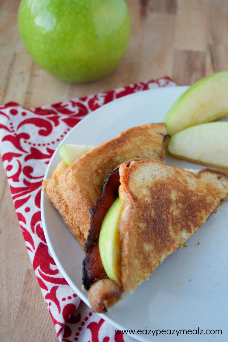 sliced abc grilled cheese, apples, bacon, and cheddar cheese grilled cheese sandwich
