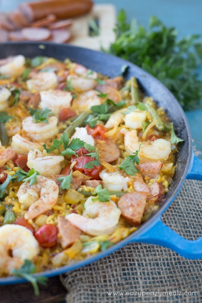 Easy Spanish Paella Recipe: Saffron infused rice, hearty sausage, prawns, and fresh green beans! This Spanish Paella will take your tastebuds on a Valencian vacation.