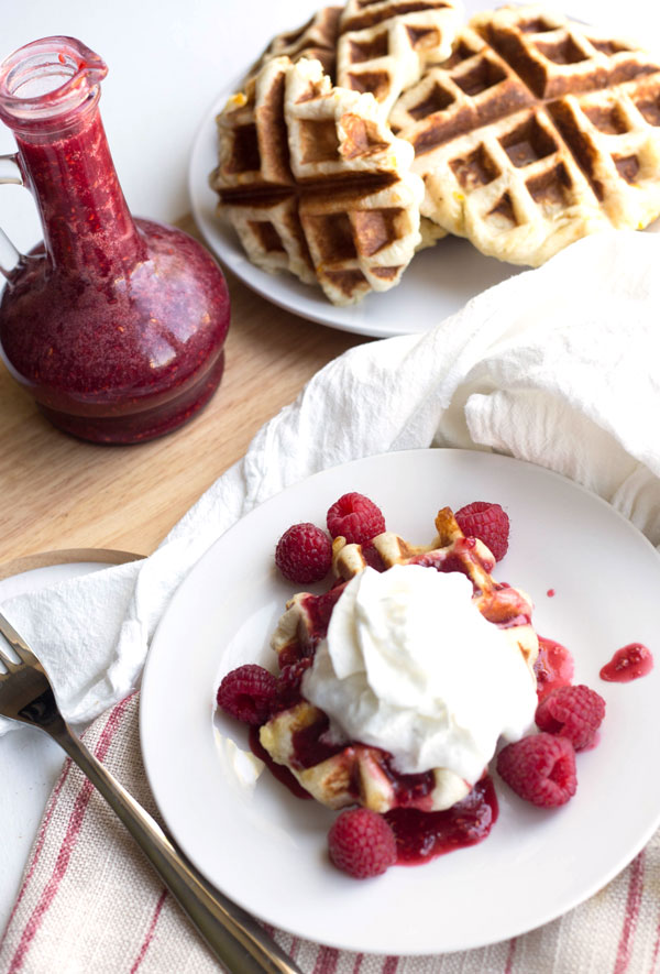 Rhodes orange rolls cooked in a waffle iron, and topped with homemade raspberry syrup