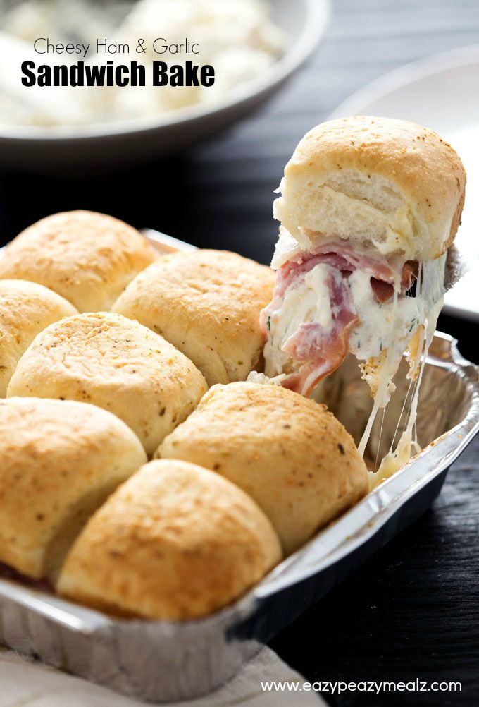 Cheesy Ham and Garlic Sandwich Bake: Whole wheat rolls filled with melty cheese and ham in a foil tray