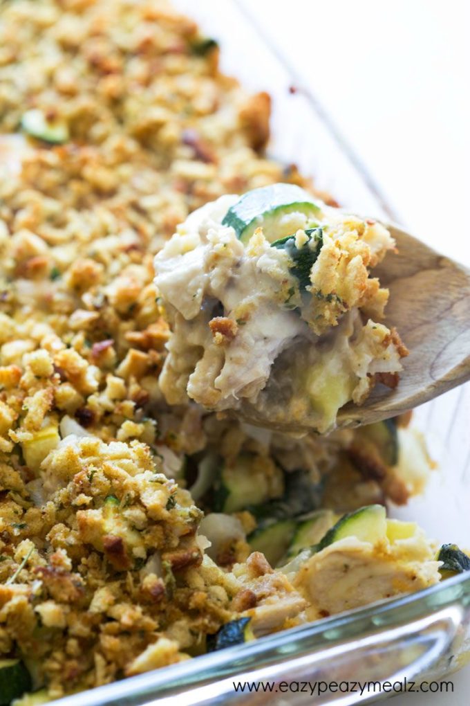 Cheesy Turkey Zucchini Casserole: Casserole in a glass dish being served by a wooden spoon 