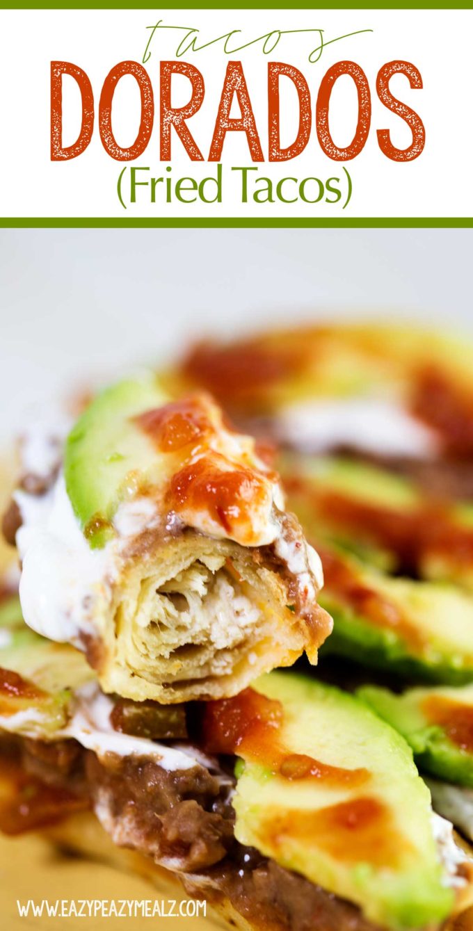 Tacos Dorados or fried tacos filled with tender chicken and cheese and topped with beans, sour cream, avocado, and salsa