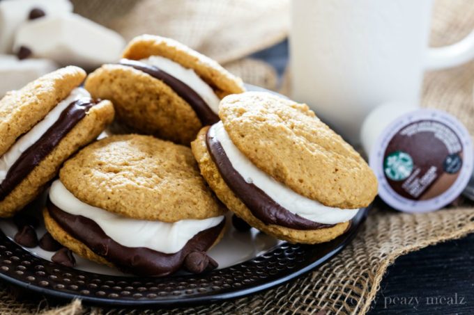 S'mores Whoopie Pie by the plateful! Graham cracker cake cookies with chocolate ganache and a tasty marshmallow buttercream, that perfectly compliments the new Starbucks® Hot Cocoa K-Cup® pods.