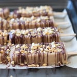 Healthy yet absolutely mouthwatering Peanut Butter Banana Popsicles with chocolate and peanut pieces stuck to them. Are you drooling yet?