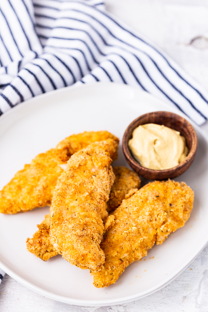 far away shot of air fryer chicken cutlets on a plate