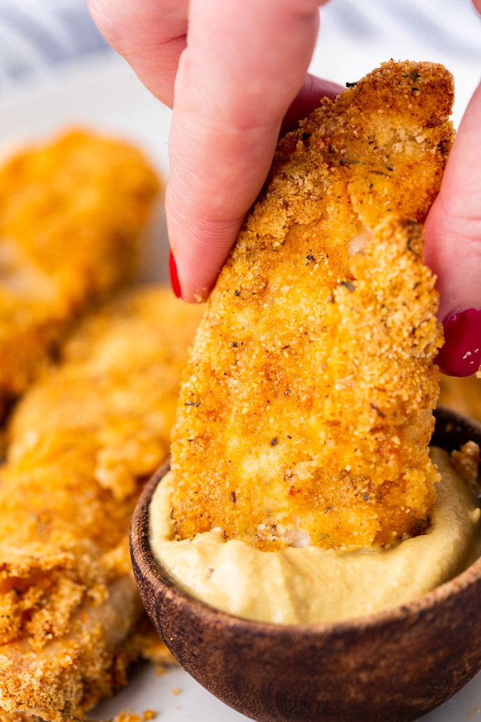 air fryer chicken cutlets dipped into sauce 