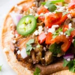 These carnitas tostadas are crispy, with black beans, the best carnitas, and all your favorite toppings.
