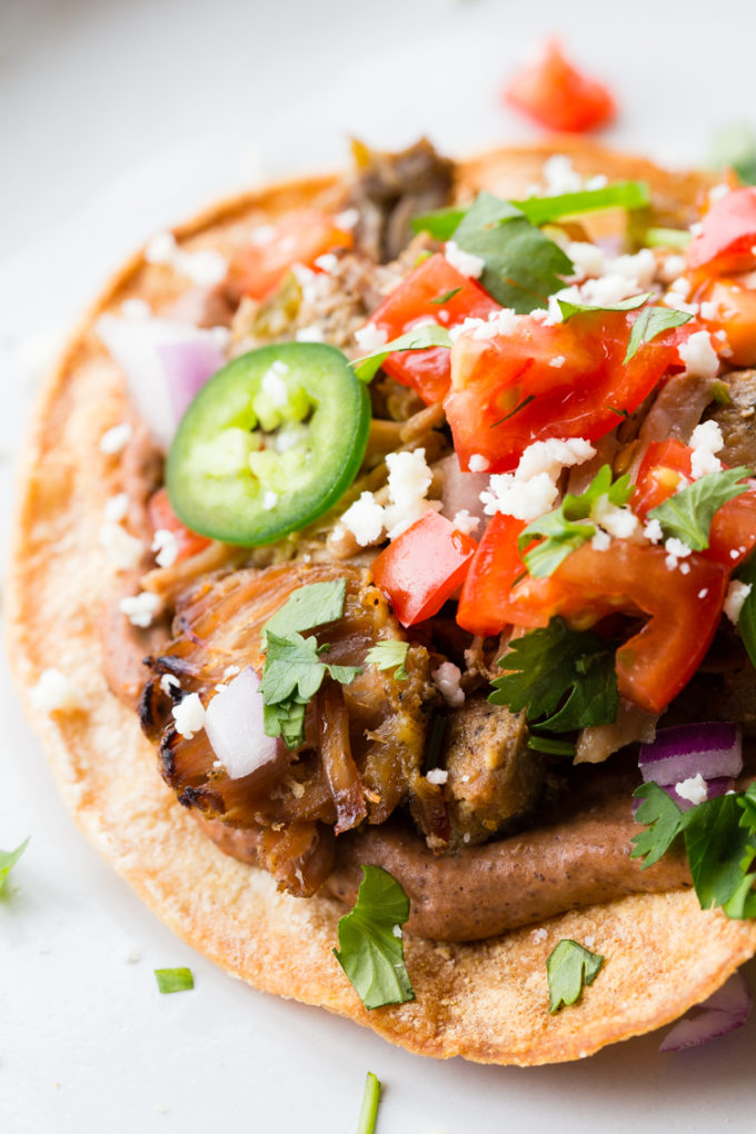 These carnitas tostadas are crispy, with black beans, the best carnitas, and all your favorite toppings. 