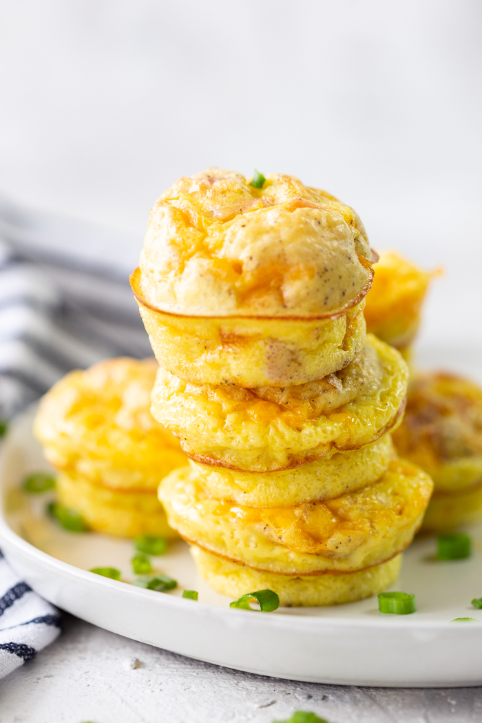 cheddar and ham egg cups on a white plate