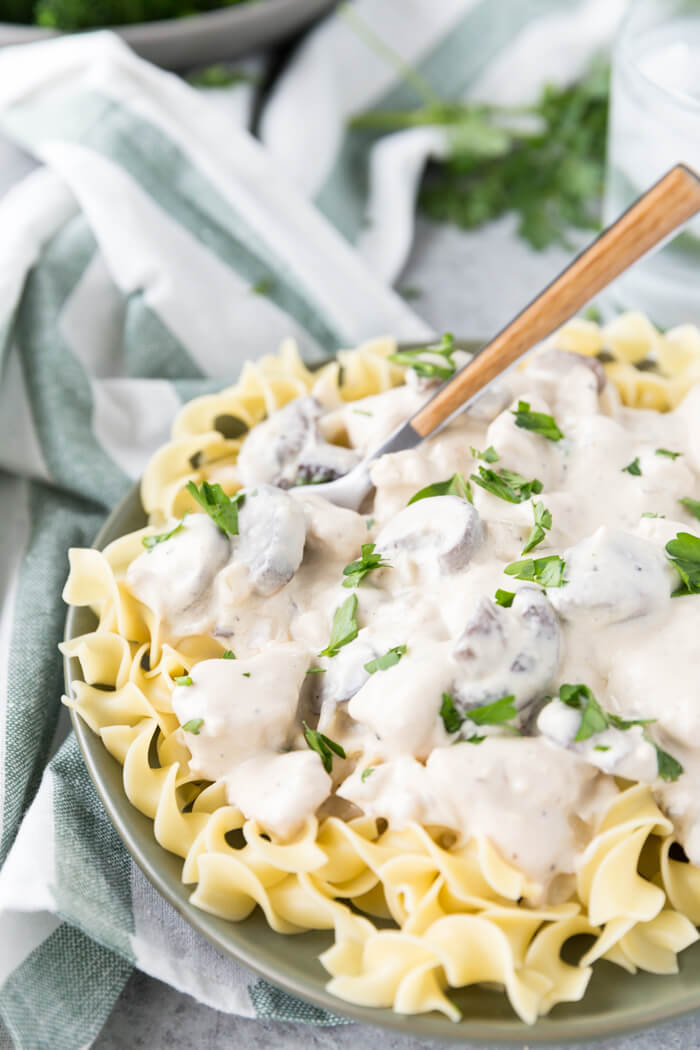 chicken stroganoff off a plate with a fork.