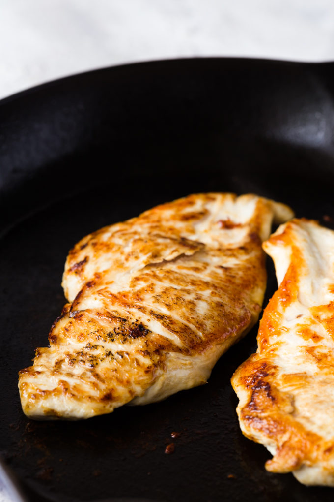 Searing the creamy tuscan skillet chicken on each side. 