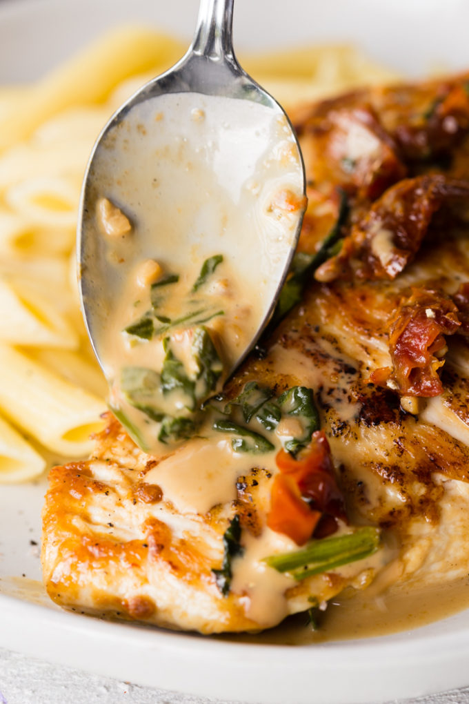 Spooning sauce over seared chicken