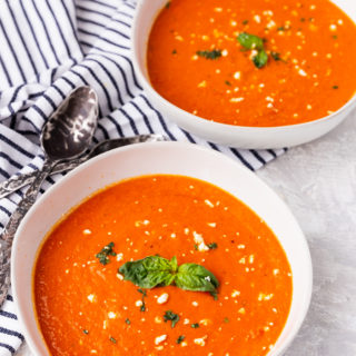 two bowls of feta tomato soup keto with spoons