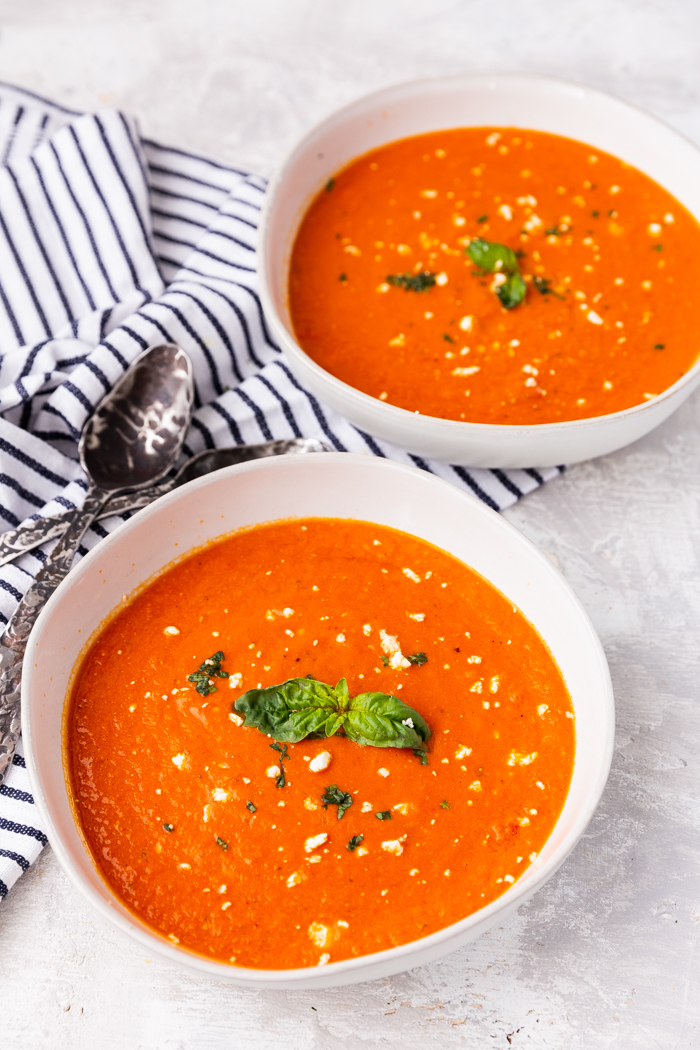 two bowls of feta tomato soup keto with spoons