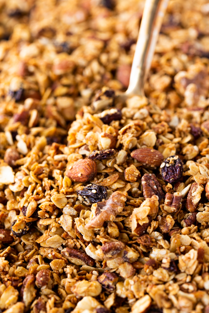 Granola mix with a spoon scooping the granola.