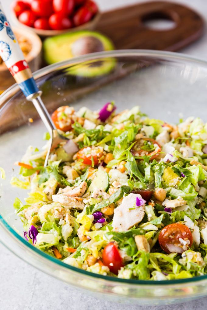 A delicious Greek Chicken Chopped Salad filled with chicken, greek veggies, and a greek vinaigrette. 