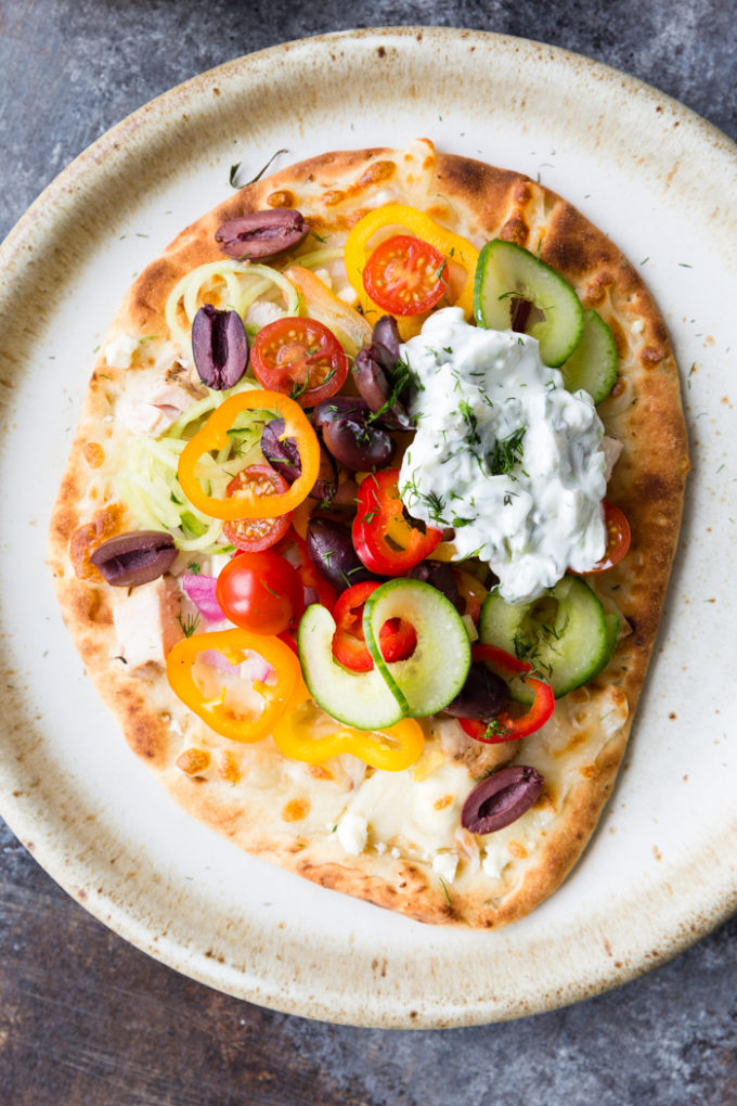 greek chicken flatbread on a plate.