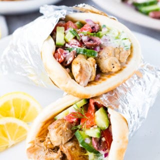 Greek Chicken Gyros cooked in the Instant Pot pressure cooker, and layered with homemade tzatziki and Greek salad