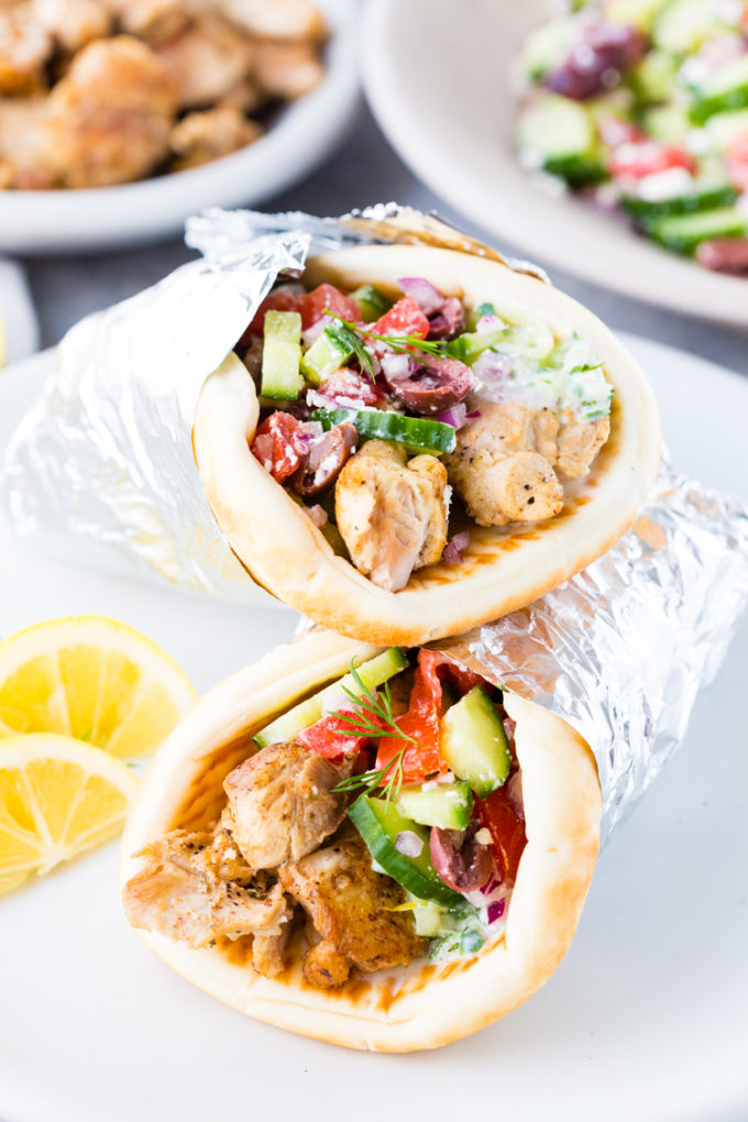 Greek Chicken Gyros cooked in the Instant Pot pressure cooker, and layered with homemade tzatziki and Greek salad