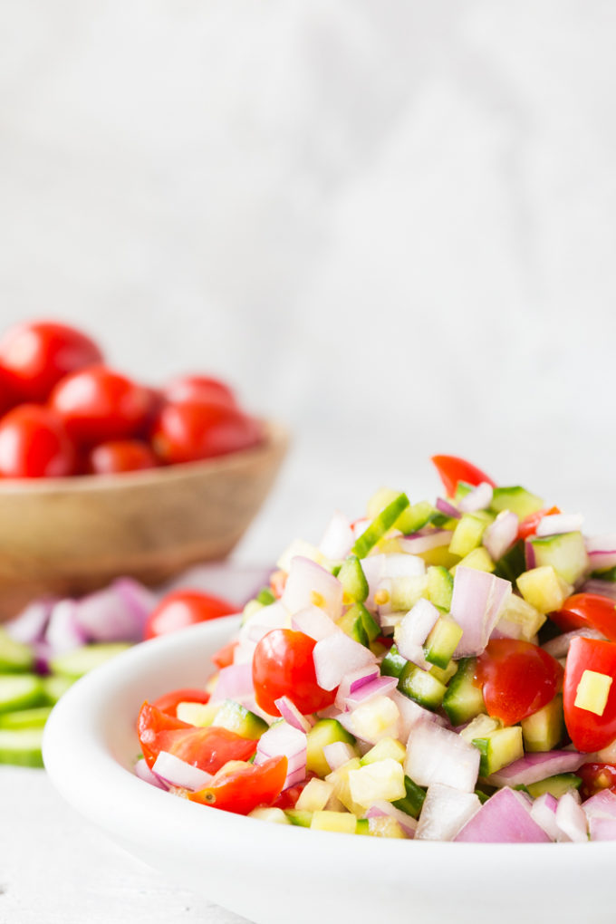 greek chicken nachos ingredients. Tomatoes, olives, onions, etc.