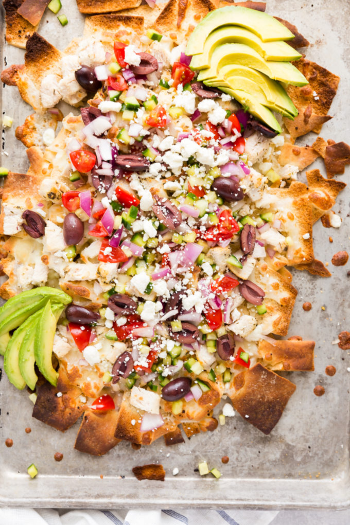 greek chicken nachos with pita chips and toppings