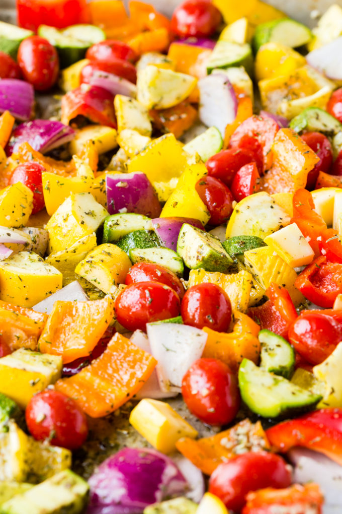 A sheet pan of color vegetables sprinkled with greek seasoning