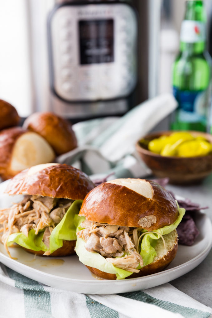 Instant Pot Mississippi Chicken made into sliders with pretzel buns