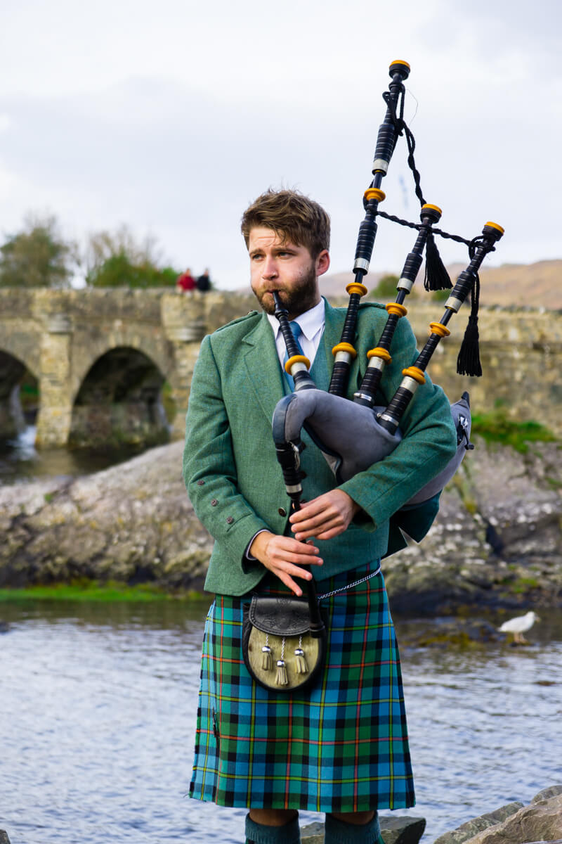 Bag Piper at Eilean Donan Castle in Isle of Skye Scotland