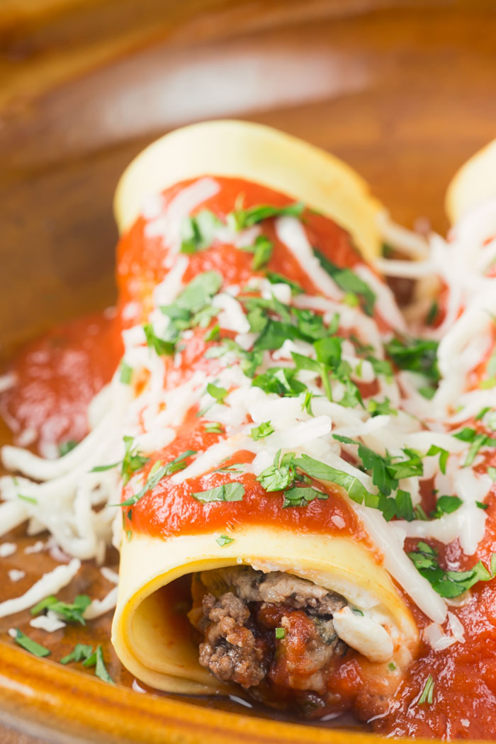 A plate with a lasagna roll up on it