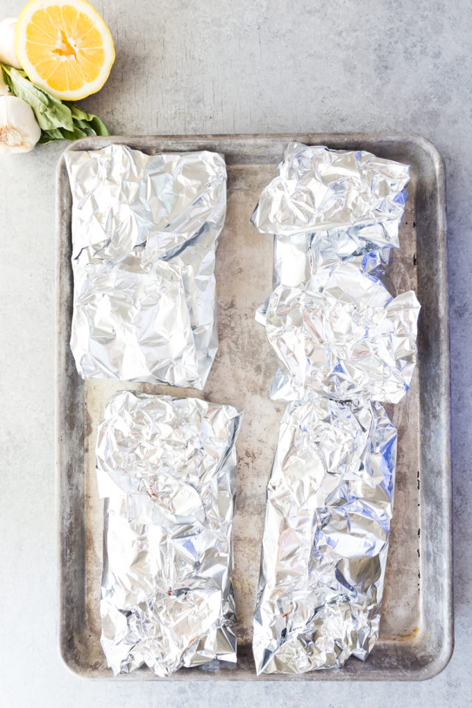 Cooking lemon butter salmon foil packets, baking them delicious