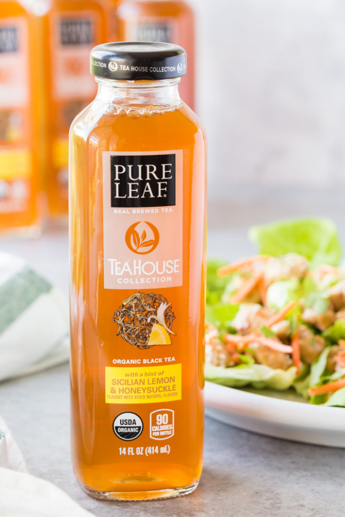 A bottle of Tea House Collection Pure Leaf tea with lettuce wraps in the background. 