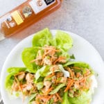 Lemon chicken lettuce wraps made with tender chicken, topped with carrots, sesame, and cilantro. Cooked in a delicious sauce.