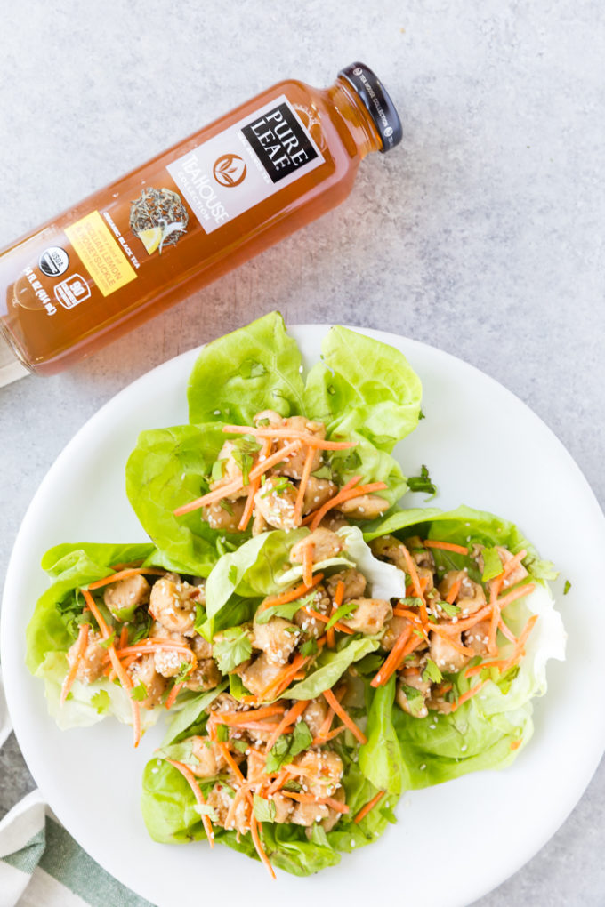 Lemon chicken lettuce wraps made with tender chicken, topped with carrots, sesame, and cilantro. Cooked in a delicious sauce. 