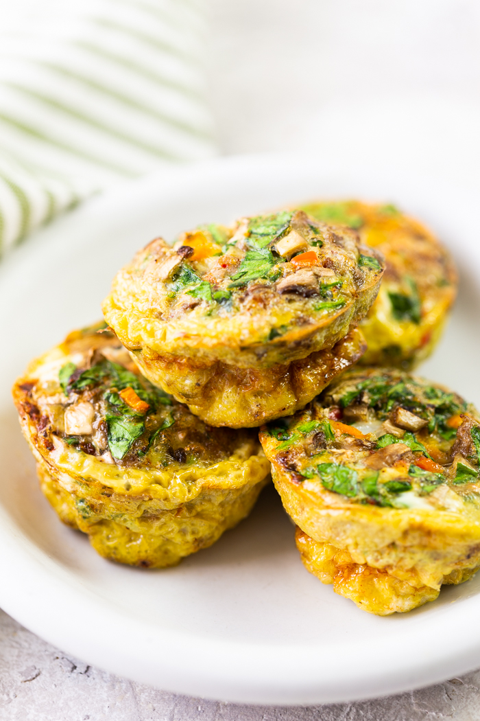 mixed veggies sausage egg cups on a white plate 