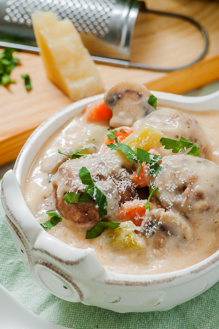 one pot creamy meatball soup, in a white bowl