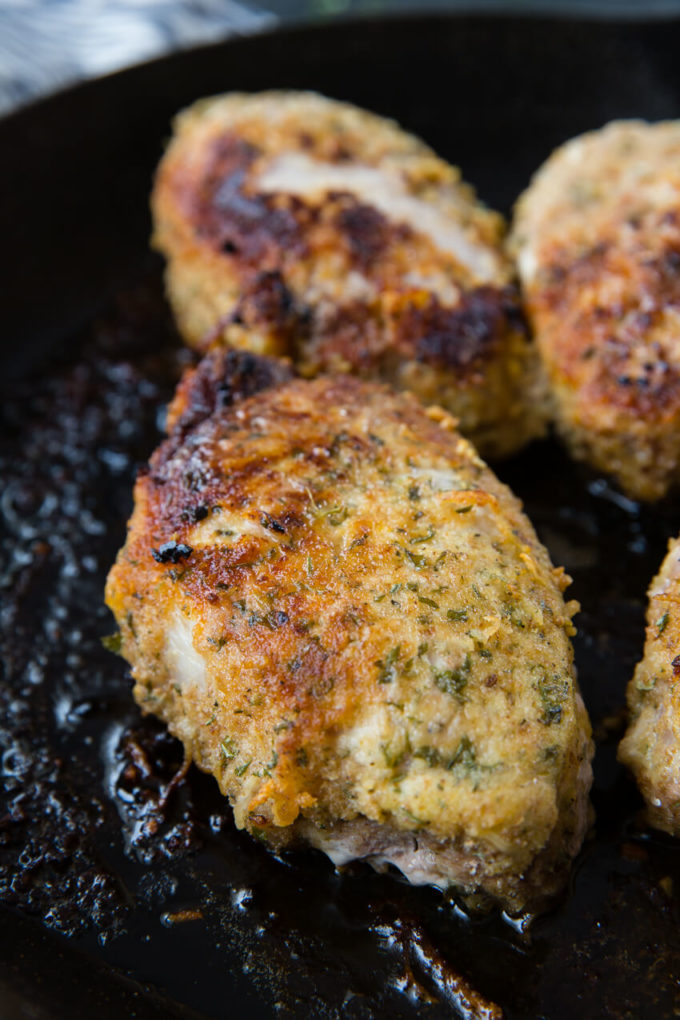 Oven baked pork chops that are breaded in Italian breadcrumbs and parmesan