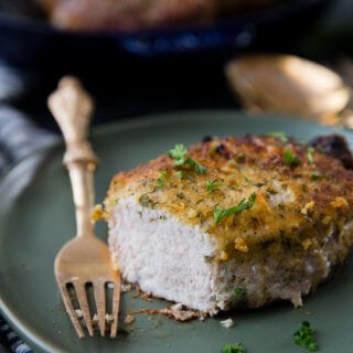 Oven baked pork chops that are breaded in Italian breadcrumbs and parmesan